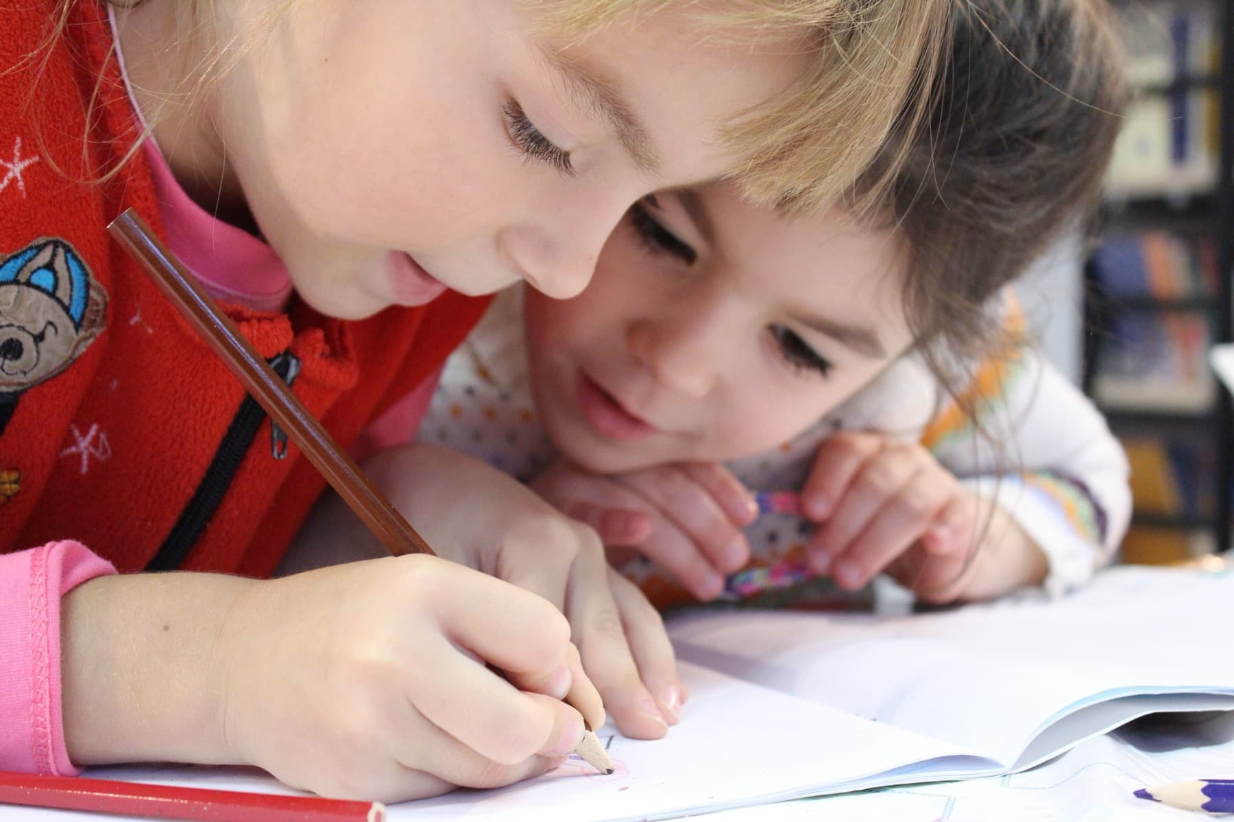 Two children writing side by side
